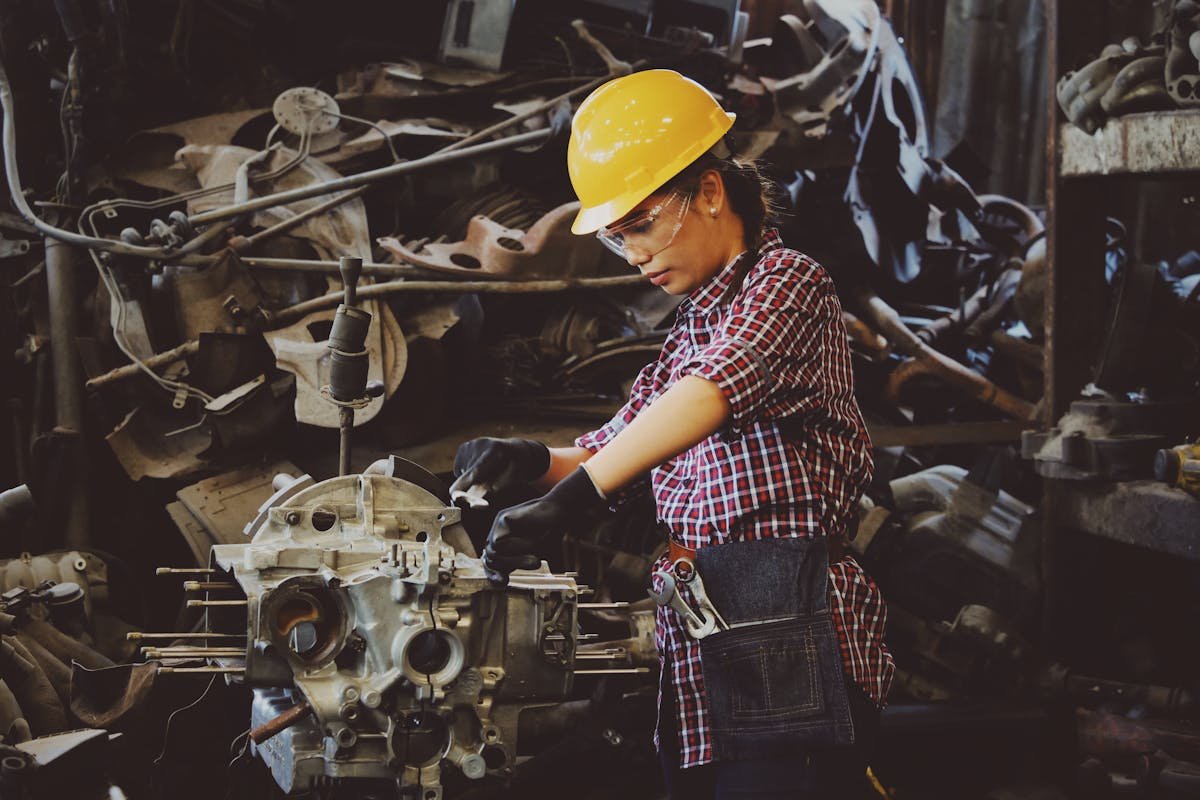 Engineer in hard hat inspecting equipment