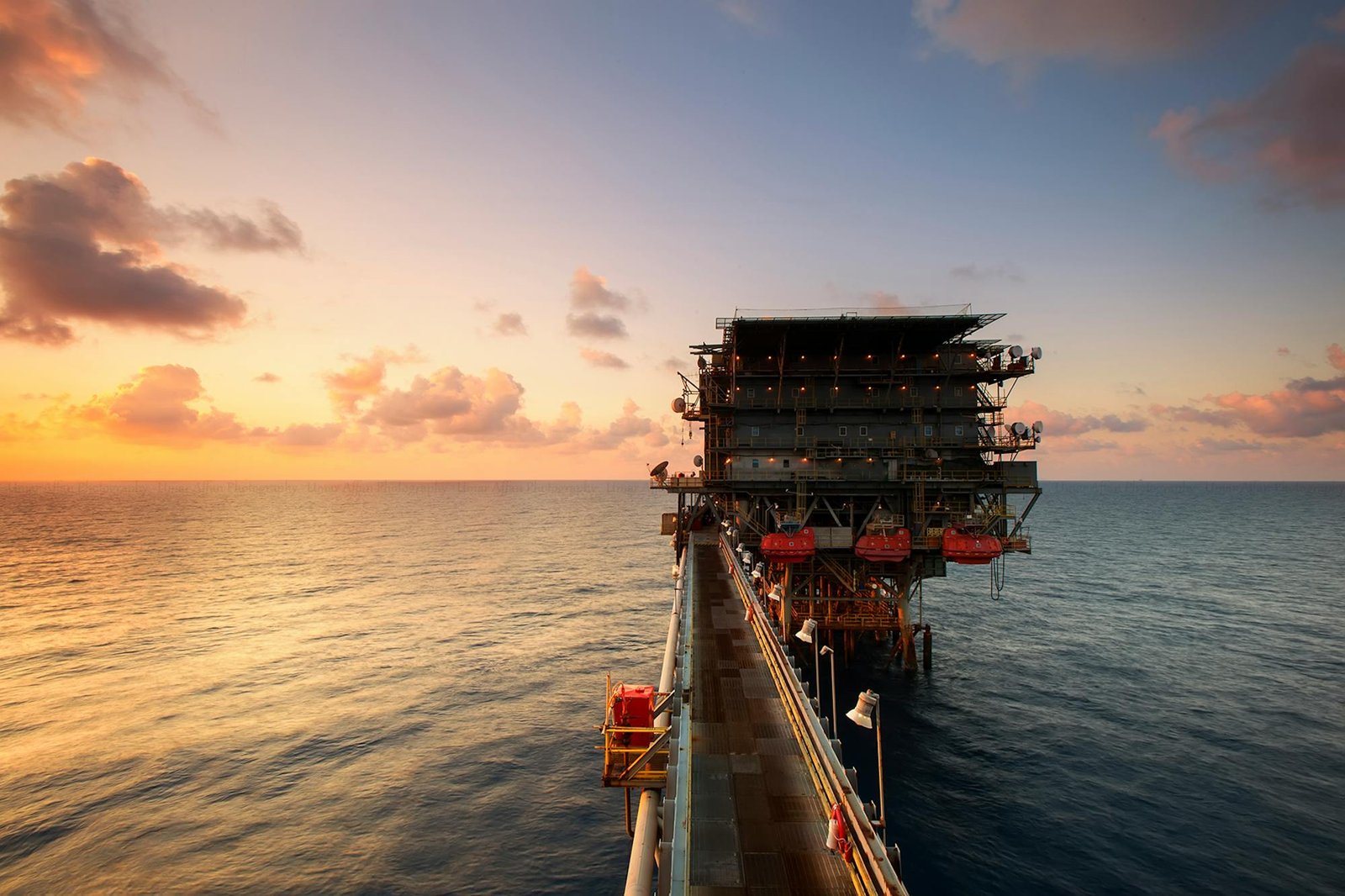 Offshore oil and gas platform at sunset
