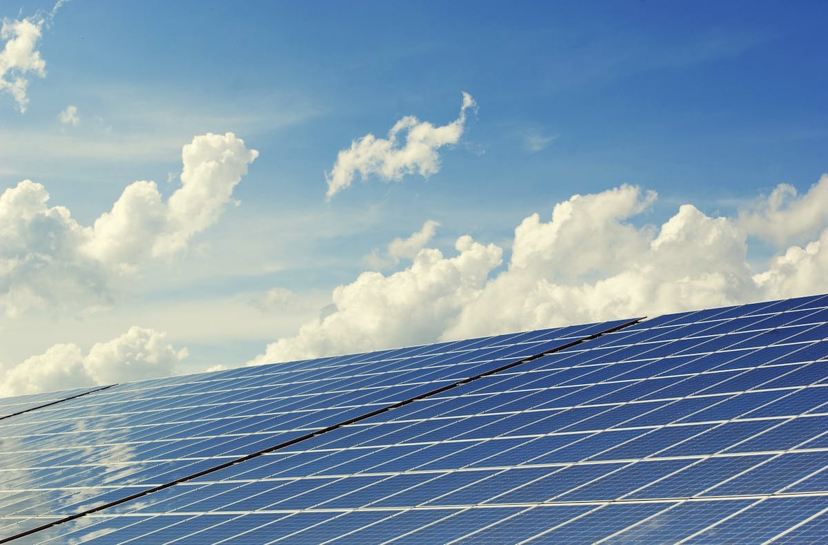 Utility-scale solar installation under bright sky